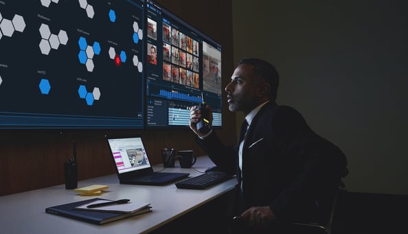 avigilon--foa--appearance-search--dark--security-operator--talking-into-radio--focused--1--cropped